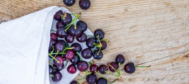 Superfoods we love cherries, whole ripe cherries on wooden board