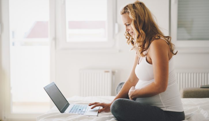 Pregnant expectant and happy  woman using technology from home