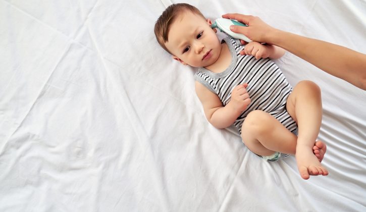 Mother measuring baby's temperature