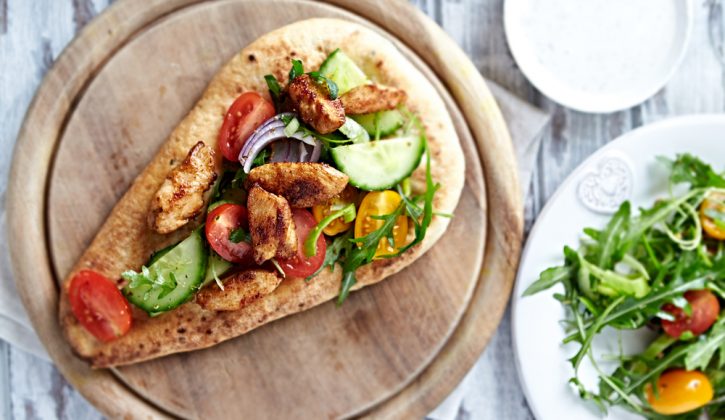 Flatbread topped with chicken and tomato cucumber salad
